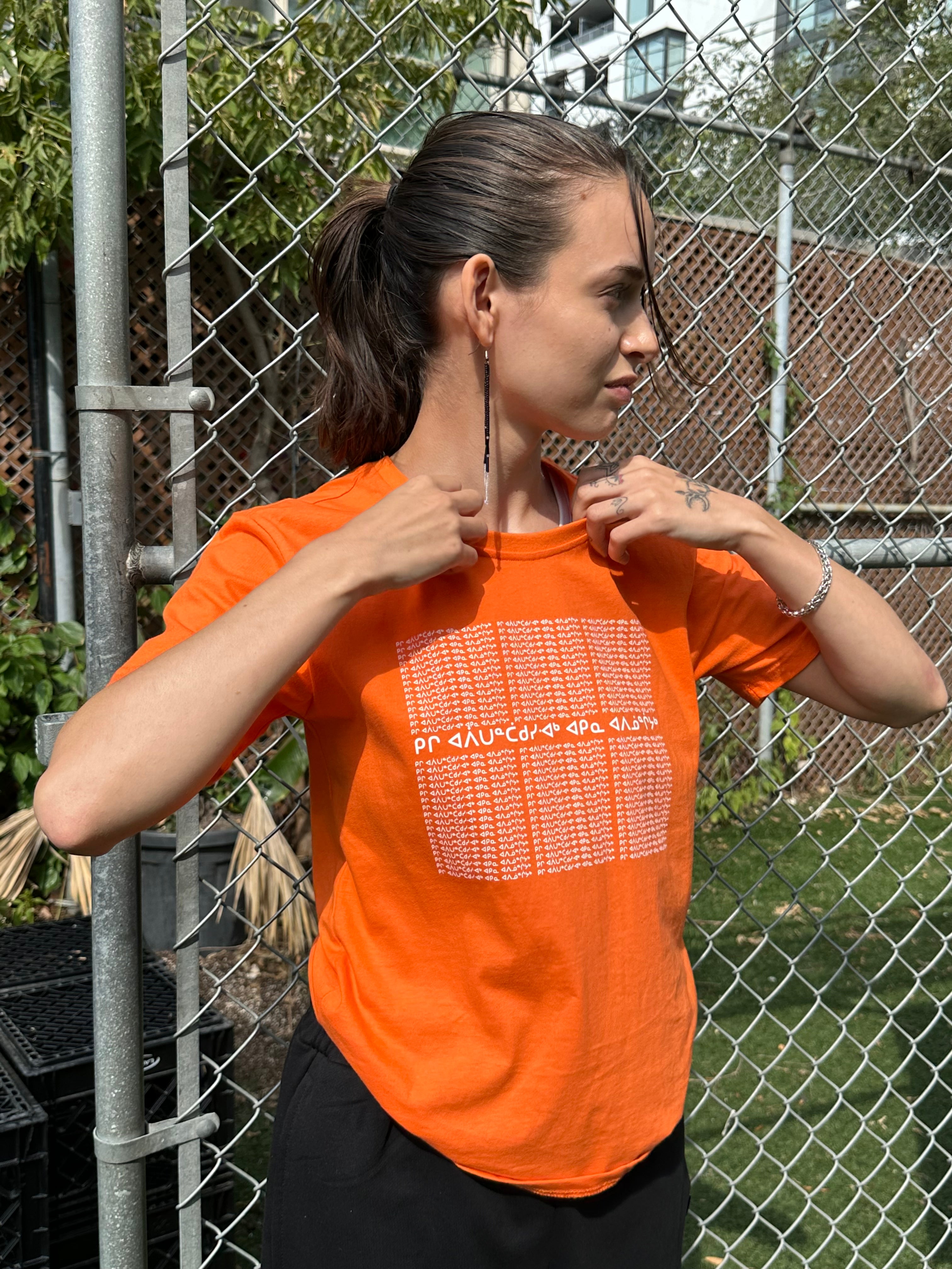 Anna, starting the conversation with aaniin by wearing an orange t-shirt with the 94 calls to action written in Anishinaabemowin syllabics honouring the Orange Shirt Society&