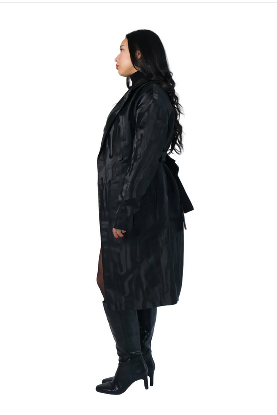 Person wearing a black trench coat on a white background
