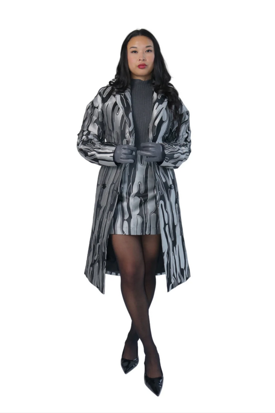 Woman wearing a patterned coat on a white background