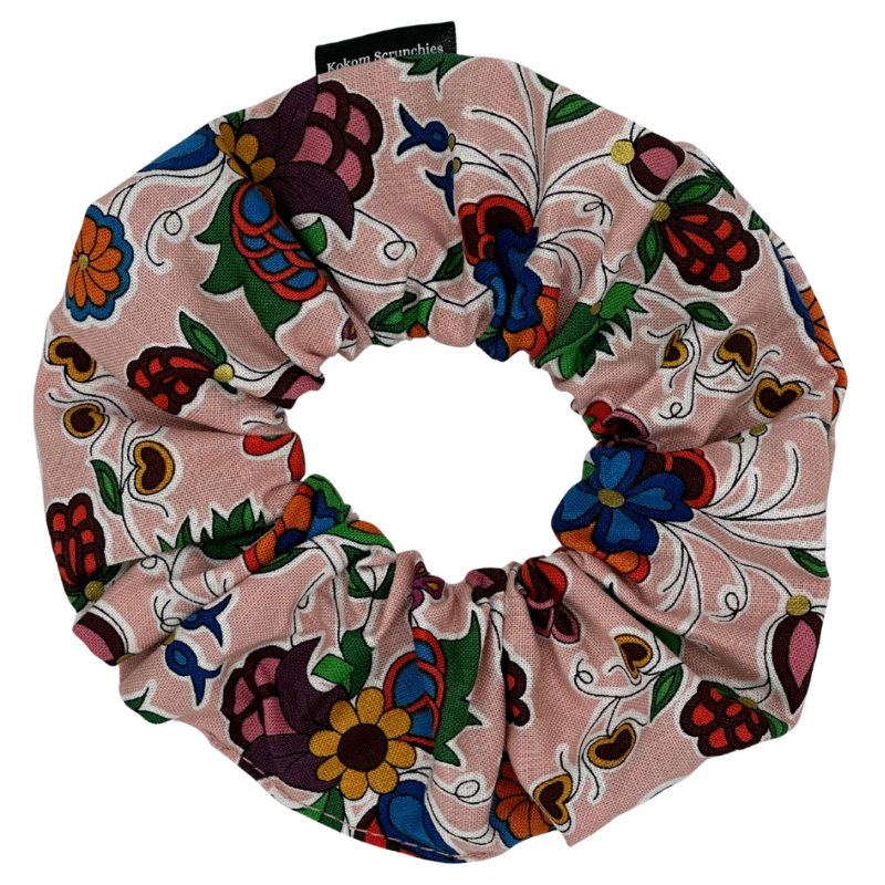 Colorful floral and abstract patterned scrunchie on a white background