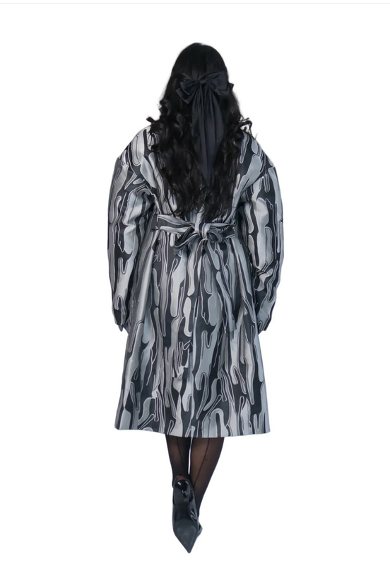 Person wearing a patterned robe on a white background