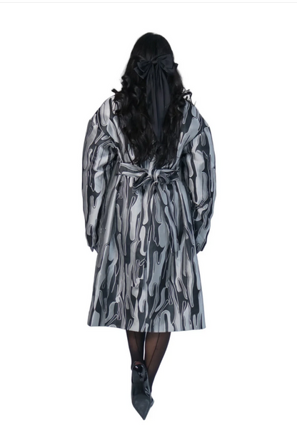 Person wearing a patterned robe on a white background