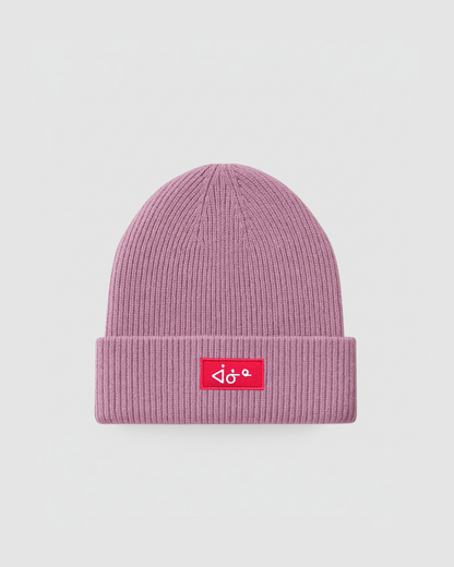 Pink beanie with a red logo on a light gray background