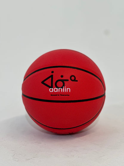 A red compost leather basketball with the brand name &
