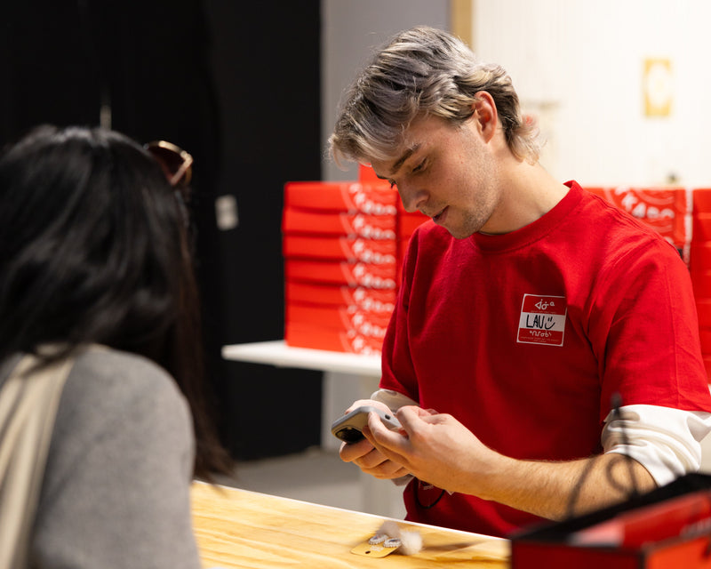 Person in red shirt interacting with another person in a store setting with 'endaaya' branding.