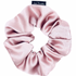 A pink satin scrunchie with a rose gold color.