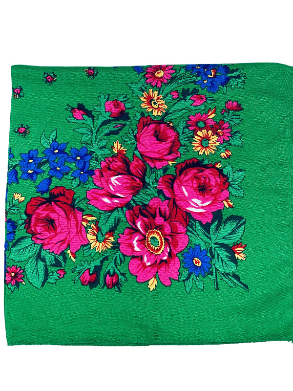 Floral patterned fabric with pink and blue flowers on a green background