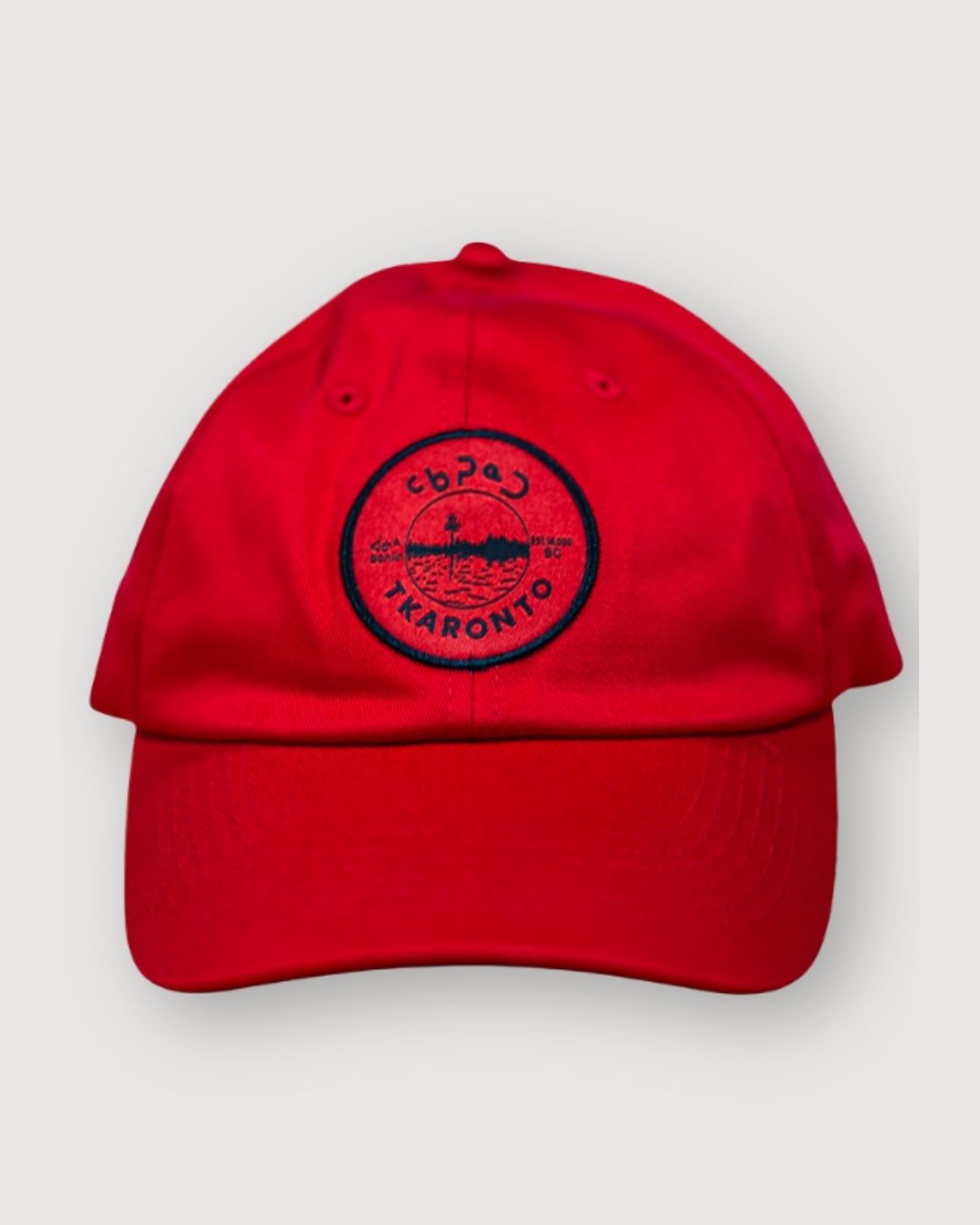 Red aaniin dad cap with the tkaronto crest on it in black to resemble the Toronto sports teams that use red and black